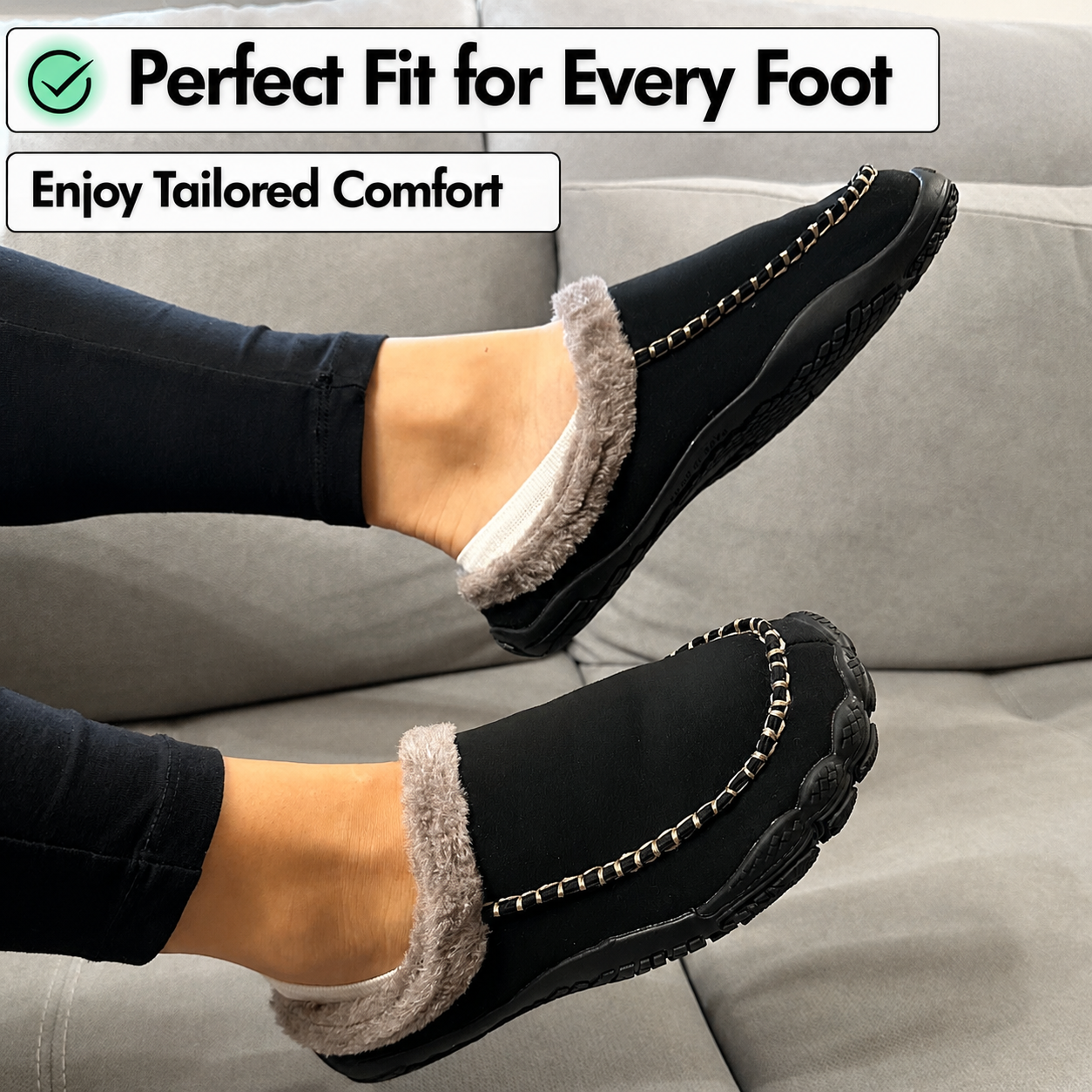 A person wearing black slip-on slippers with gray faux-fur trim and a decorative chain detail, shown sitting on a light gray couch. Text overlays at the top read 'Perfect Fit for Every Foot' and 'Enjoy Tailored Comfort'.